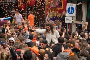 People partying on the streets during kings day in Amsterdam