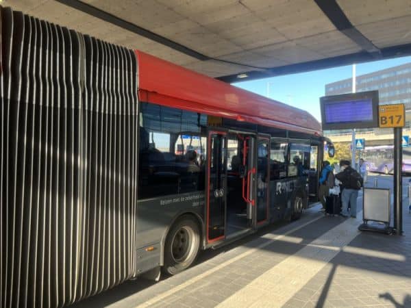 Public transport bus at Schiphol Airport ready to take passengers to Amsterdam city center.
